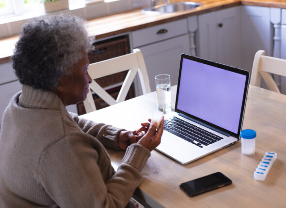 African,American,Senior,Woman,Holding,Empty,Medication,Container,While,Having